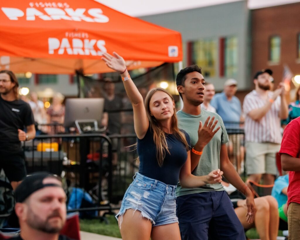 Two young adults dance and enjoy concert music